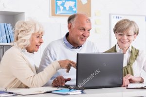 seniors looking at a laptop