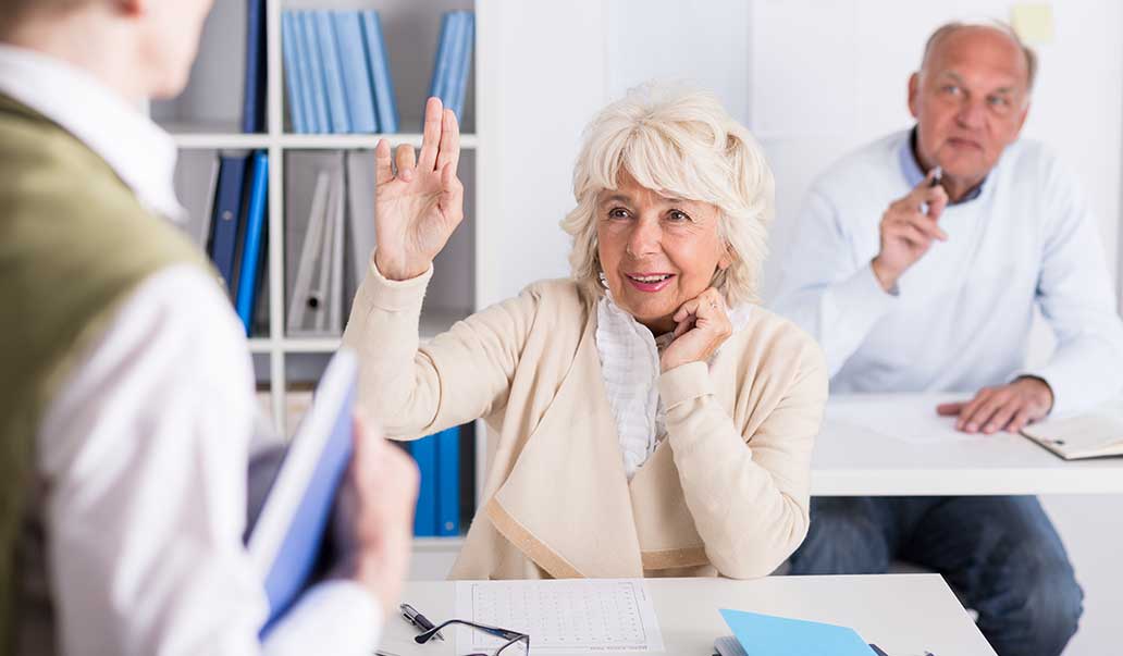 woman raising her hand in a lecture