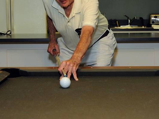 senior man playing pool