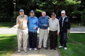 group of senior men playing horse shoe