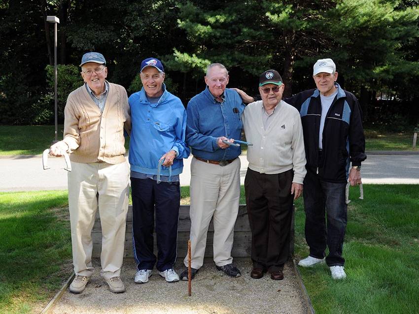 group of senior men playing horse shoe