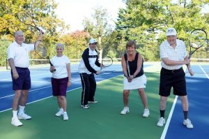 seniors posing for picture on the tennis court