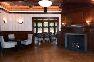 open area with fireplace leading to dining room