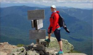 woman standing on the top of a mountain