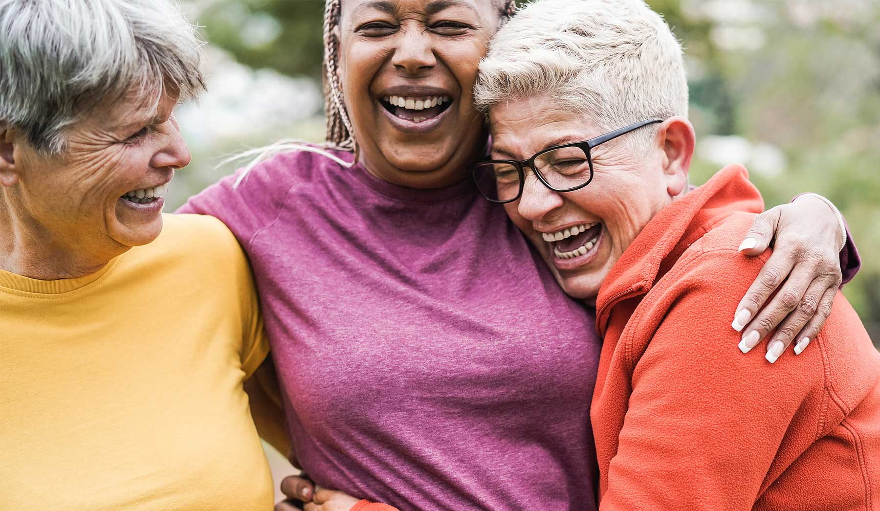 three women hugging and laughing