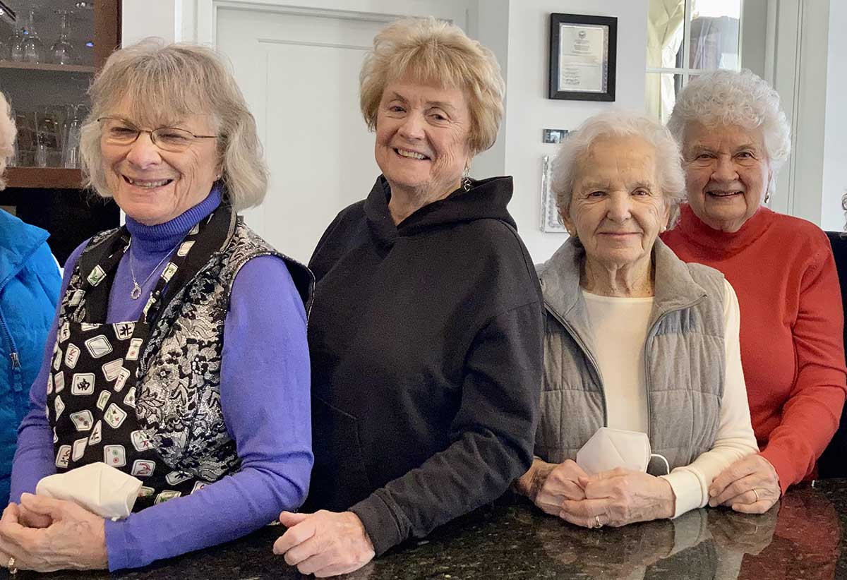 happy senior women leaning on granite counter