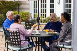 adults sitting at an outdoor table on a patio