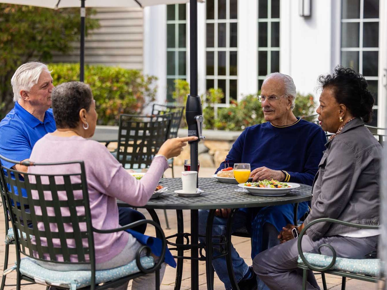 adults sitting at an outdoor table on a patio
