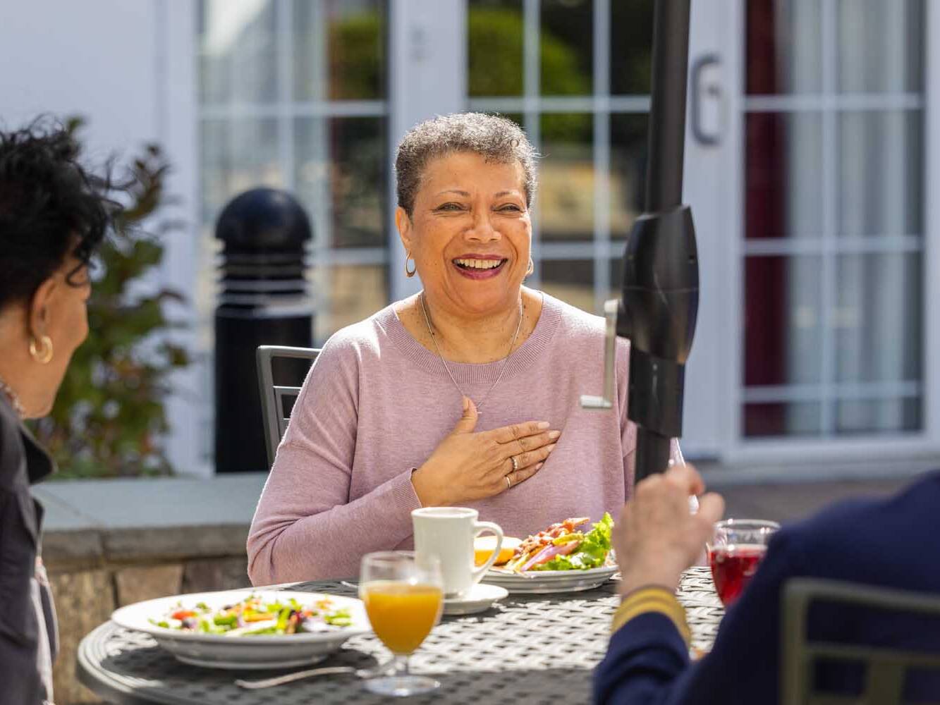 adults enjoying a meal together outdoors