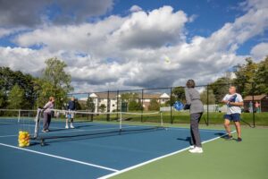 adults playing pickleball