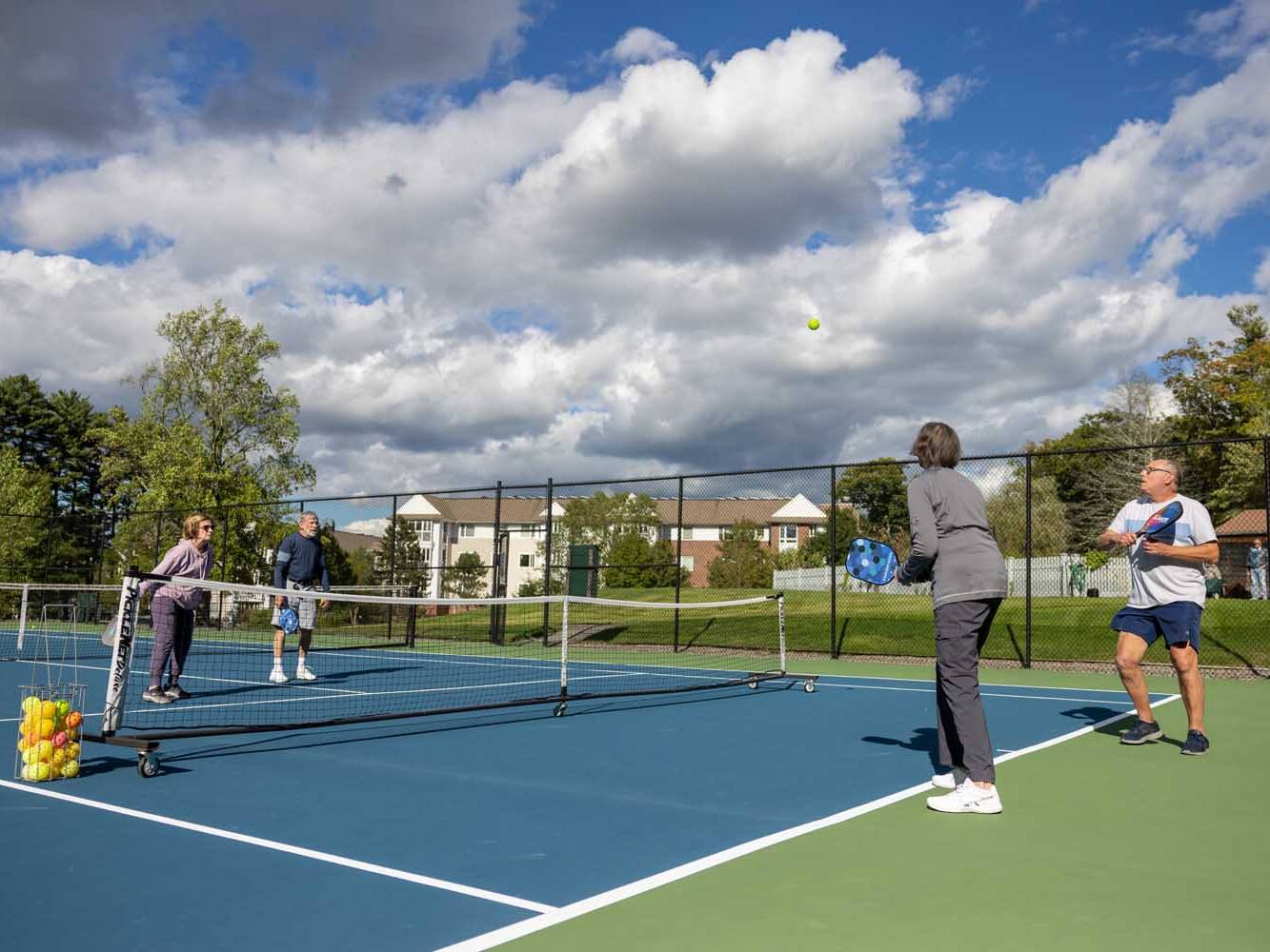 adults playing pickleball